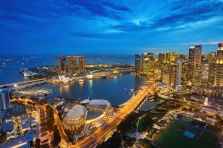 Marina Bay and Singapore’s illuminated skyline at blue hour